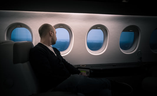 A man flying in a first class seat on an airplane. 