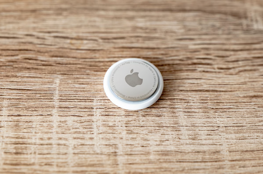 An apple AirTag sitting on a table.